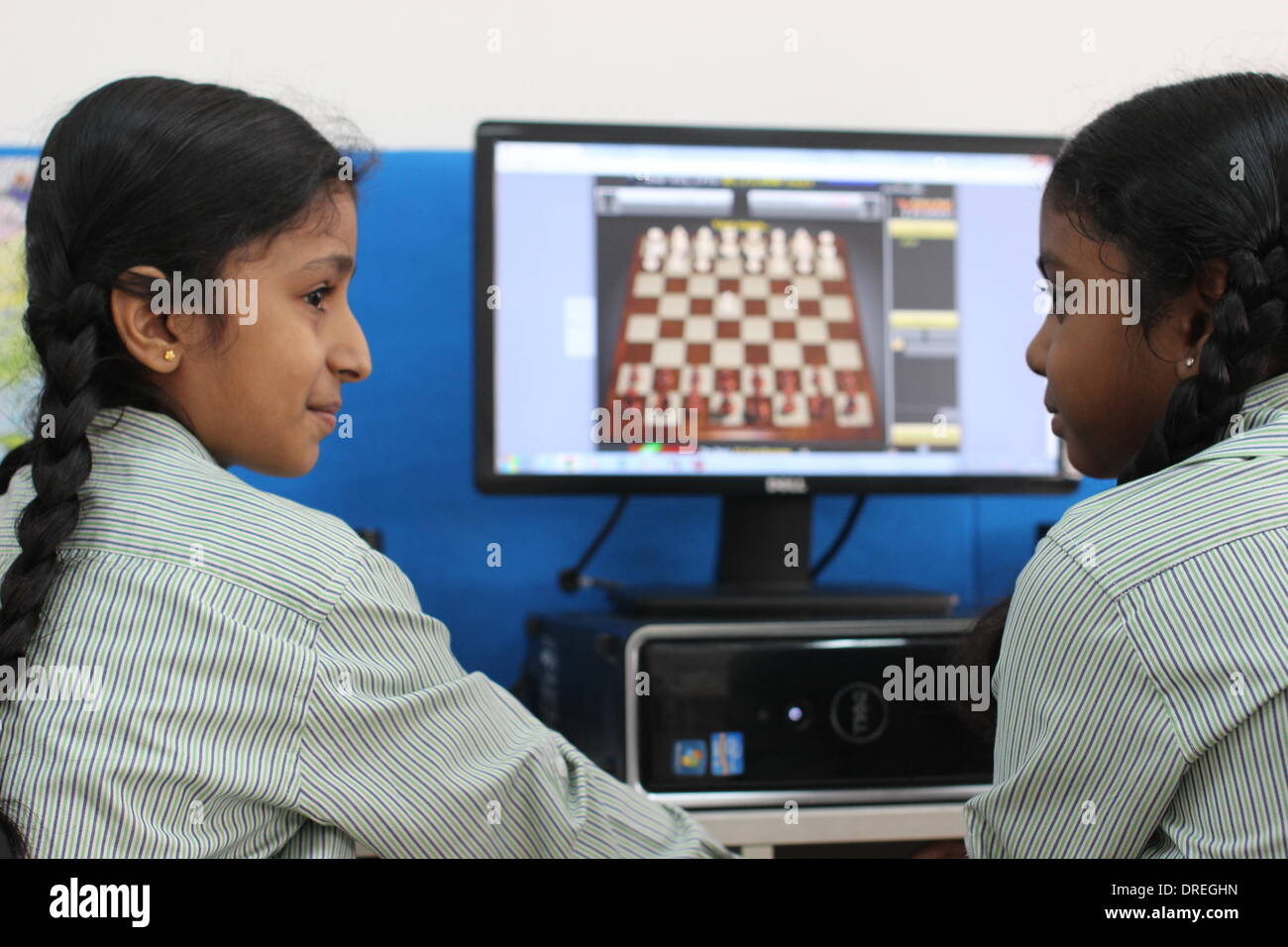 Nodia, India. 30th Oct, 2013. Two fifth graders sit in front of a computer playing an online game of chess with other pupils from across the country at the Global Indian International School in Nodia, India, 30 October 2013. Chess is becoming increasingly popular in India, since Viswanathan Anand became the first Indian chess master ever to win the title in 2000. Nowadays 1.65 million young Indian students are learning and practicing the game of chess in there schools as part of mental exercises lessons. Photo: Doreen Fiedler/dpa/Alamy Live News Stock Photo