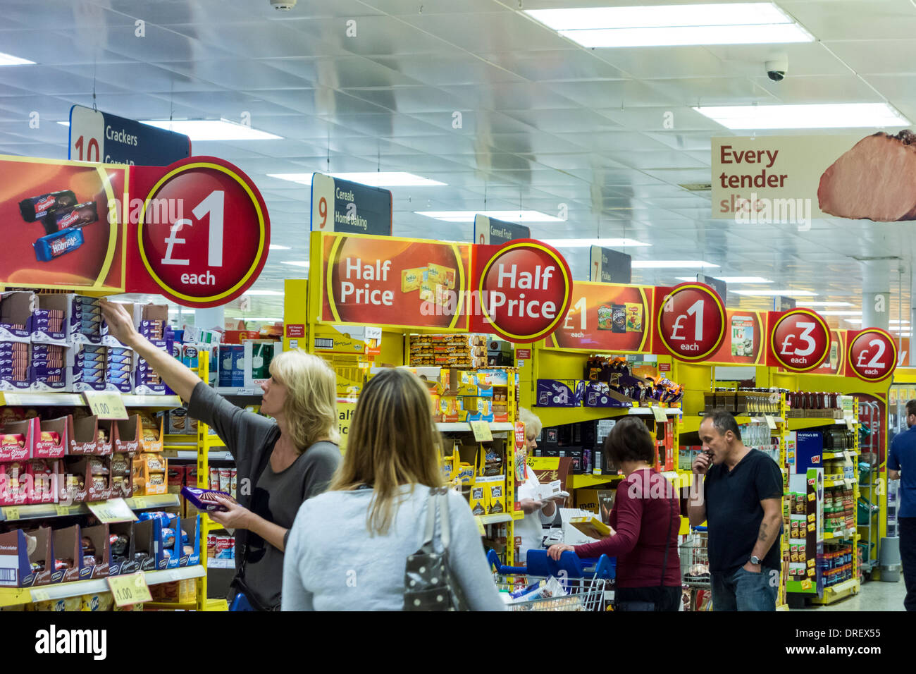 Shoppers and offer signs at Tesco Supermarket, UK Stock Photo