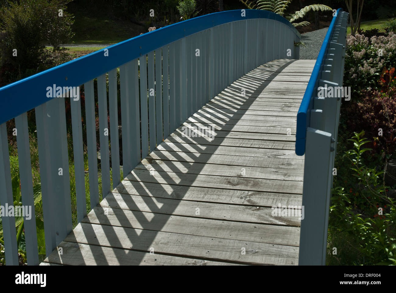 Pedestrians bridge wooden with blue handrails and shadows Stock Photo