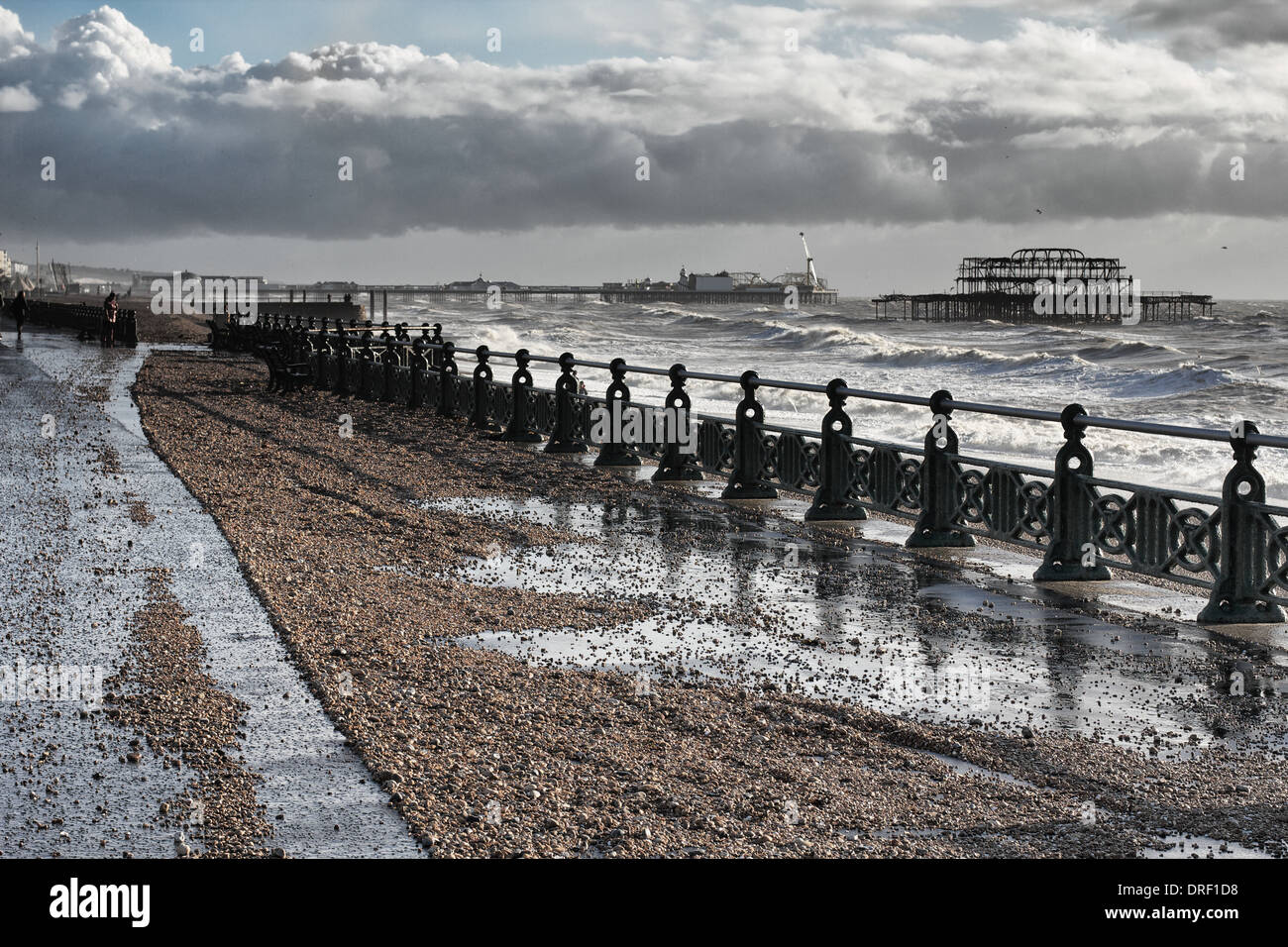 Brighton & Hove seafront in between a succession of storms. Rough sea, the piers, shingle on the promenade. Stock Photo