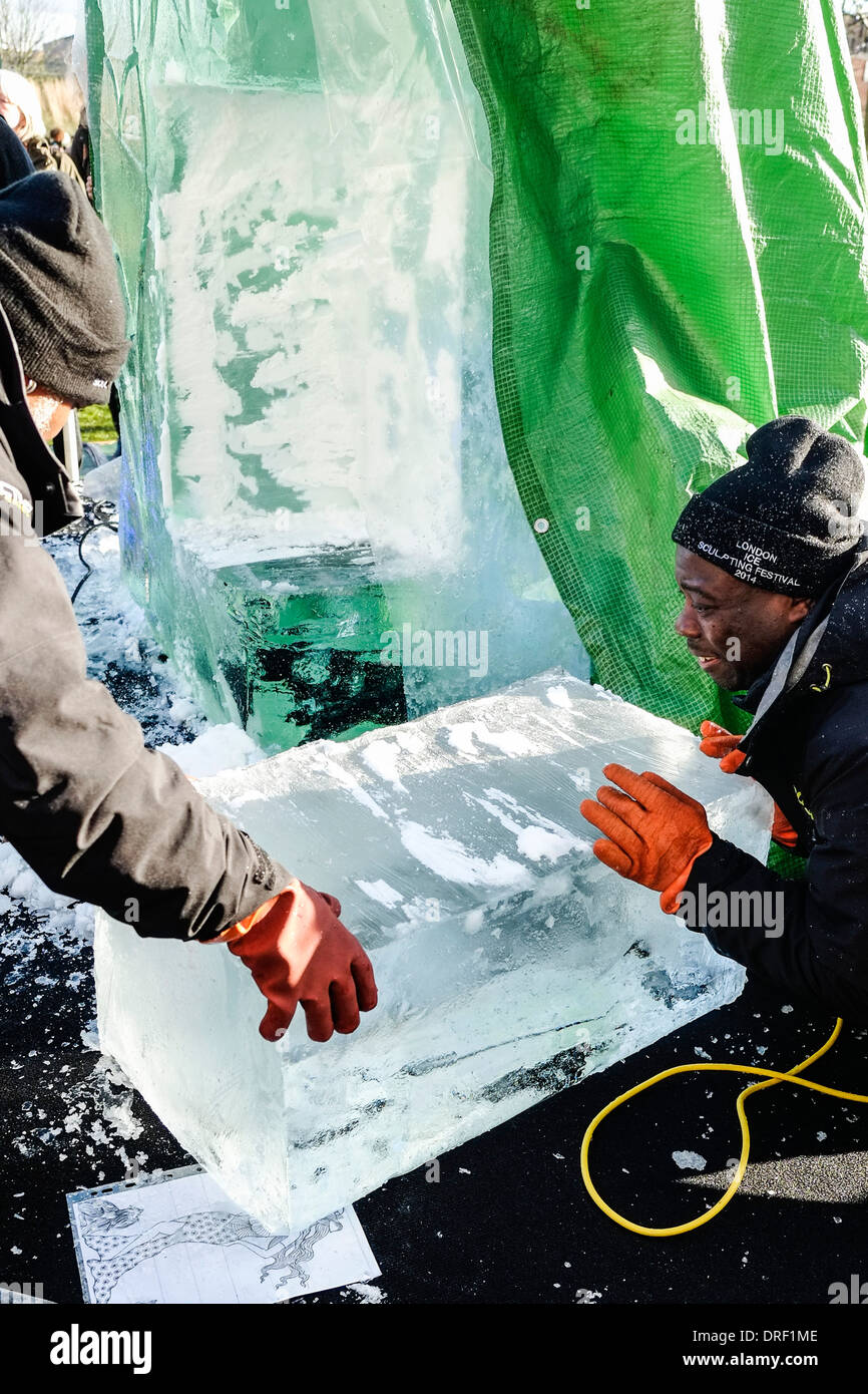 Members of the African team working together to create their sculpture as part of the 2014 London Ice Sculpting Festival. Stock Photo