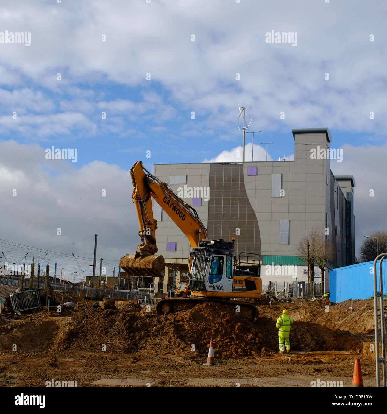 Mechanical digger at road construction site by Luton Railway Station Stock Photo
