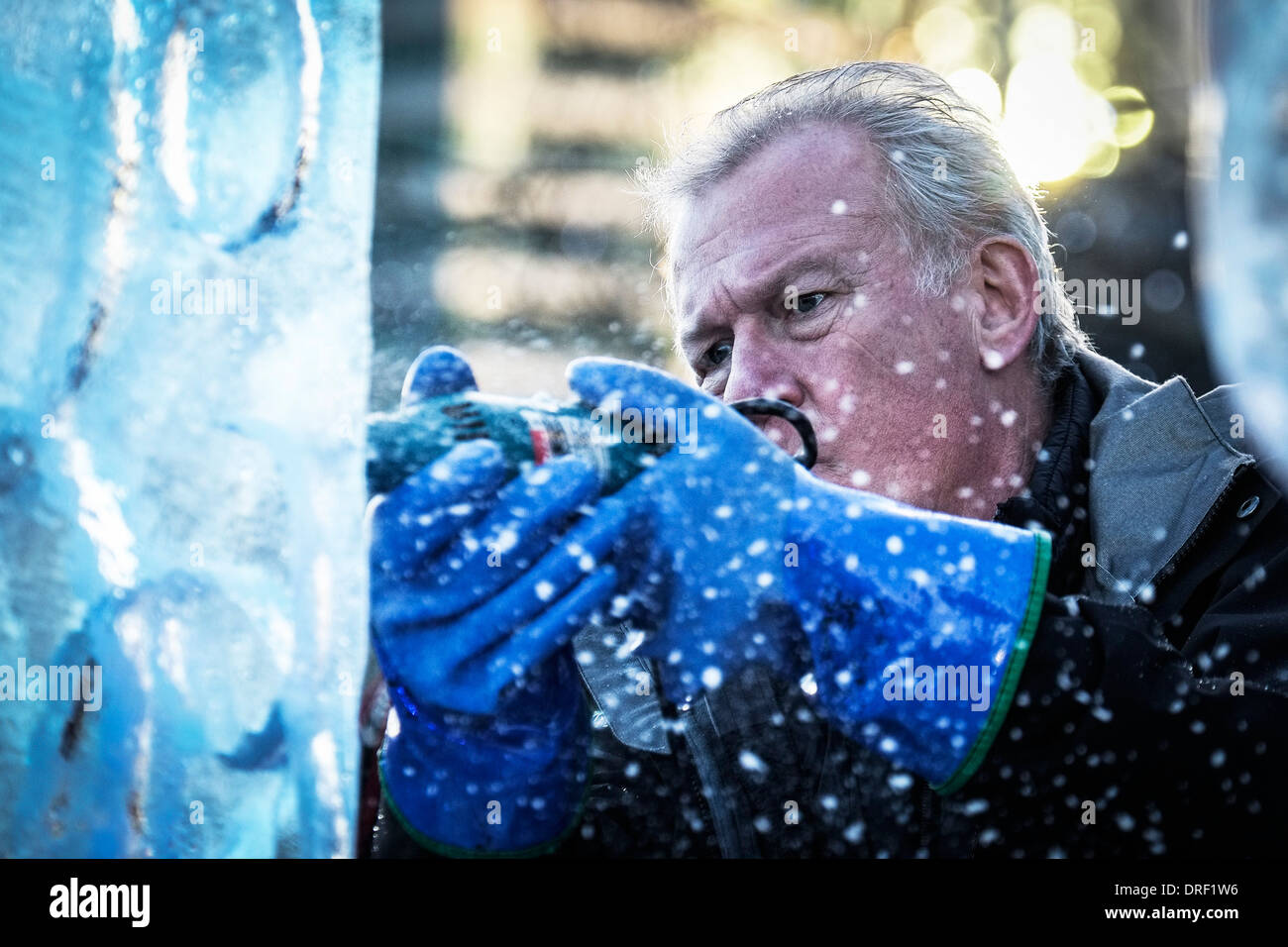 An artist working to create an ice sculpture as part of the London Ice Sculpture Festival. Stock Photo