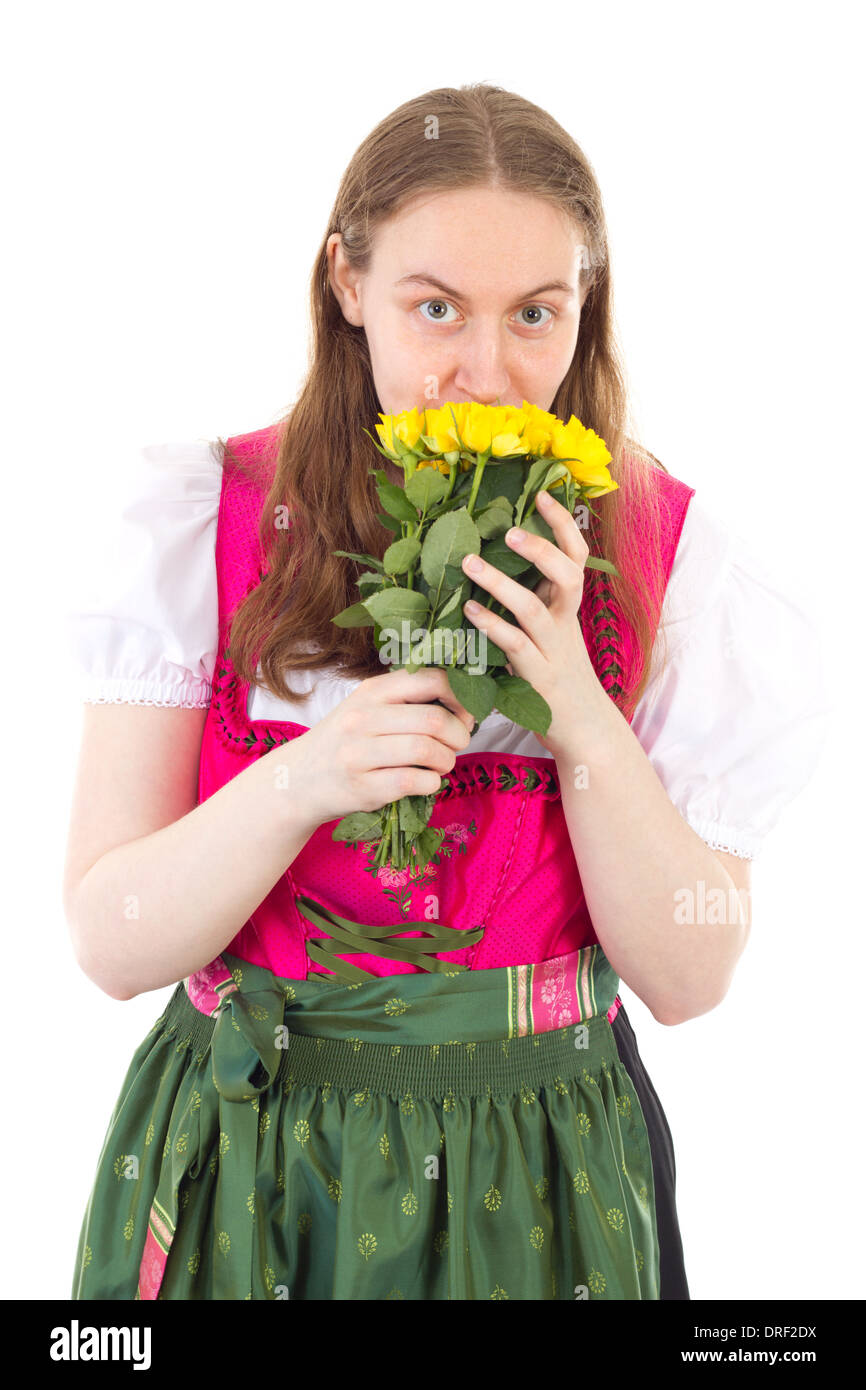 Beautiful girl in dirndl with bunch of yellow roses Stock Photo
