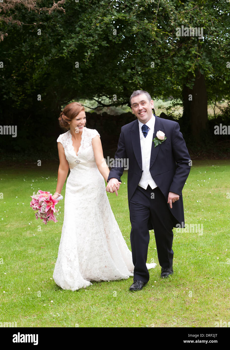 Wedding couple posing after ceremony Stock Photo - Alamy