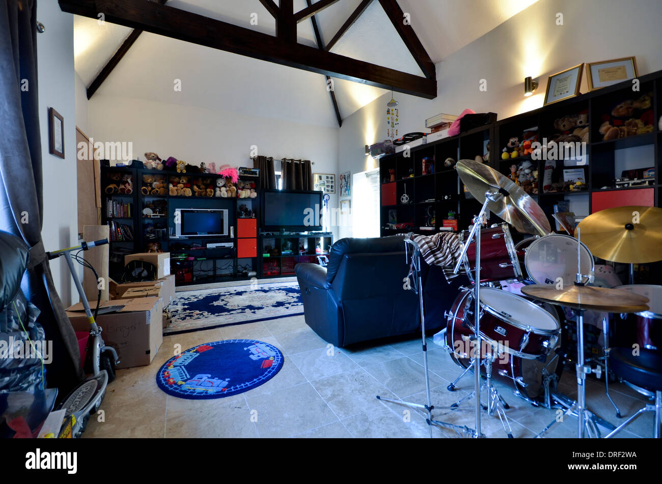 Teenagers play room with drum kit, tv and games consoles Stock Photo