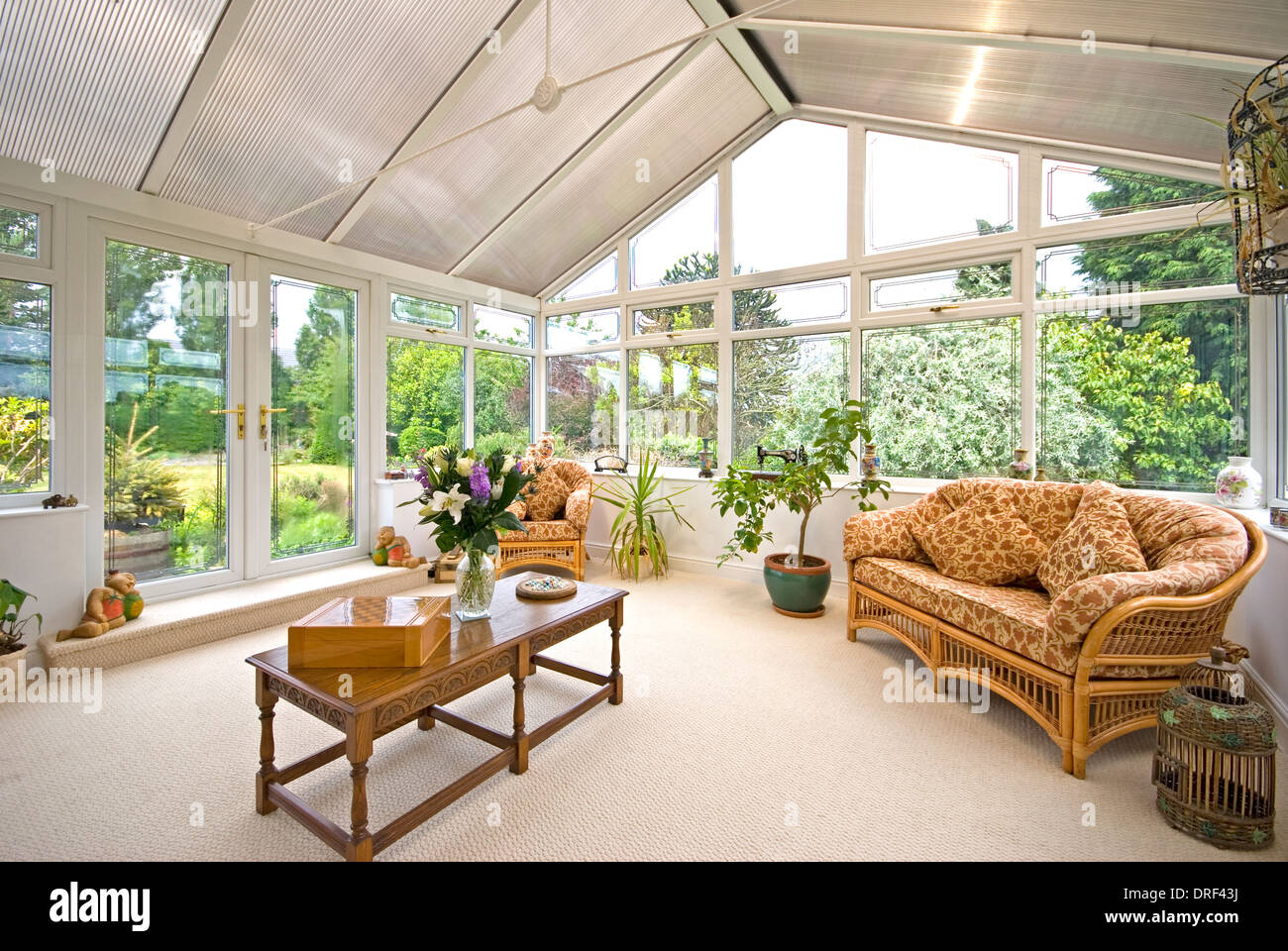 Large conservatory with wicker furniture Stock Photo Alamy