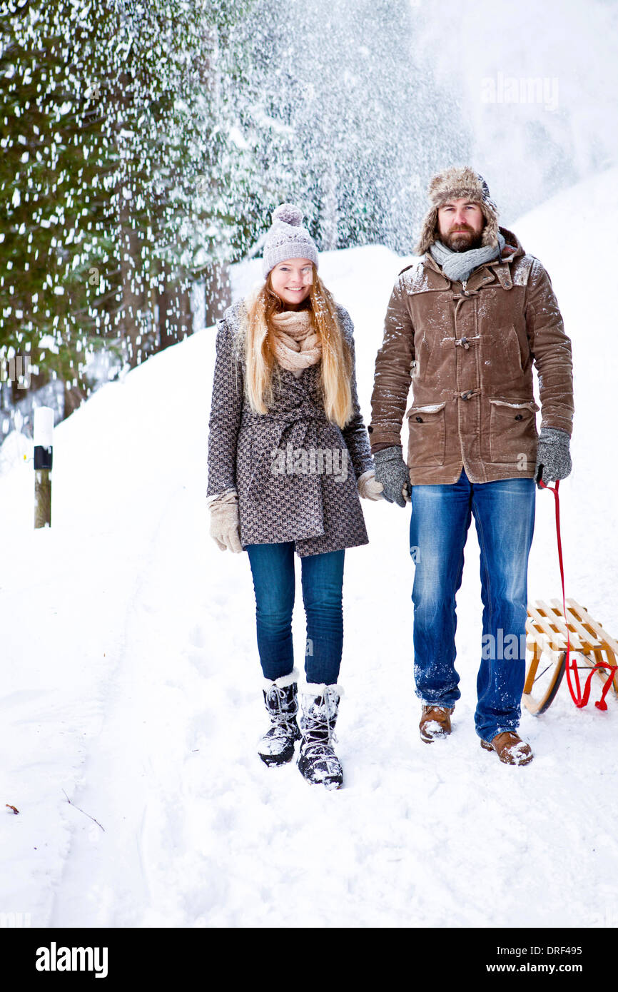 Couple Pulling Sled In Snow, Spitzingsee, Bavaria, Germany, Europe Stock Photo