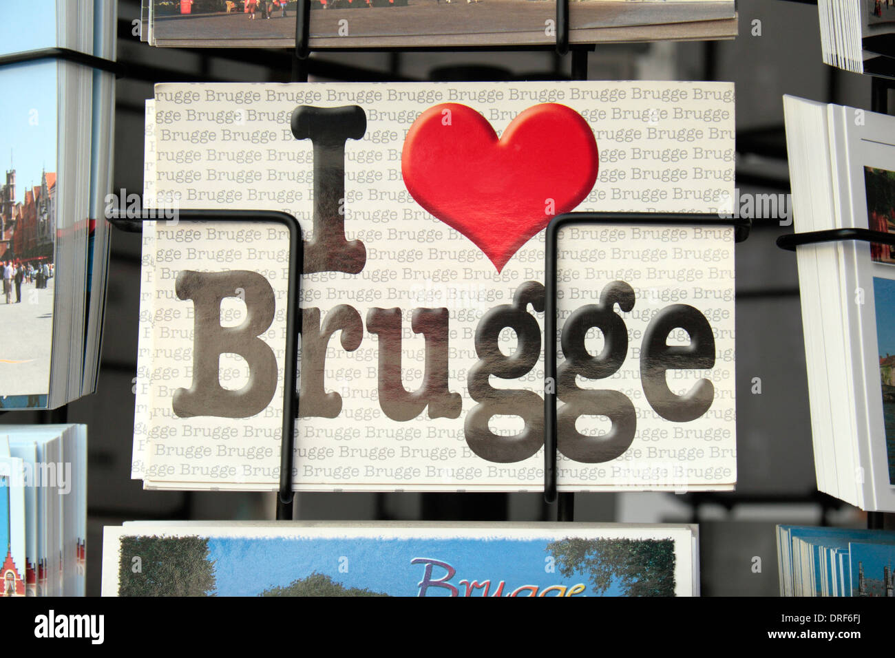 A 'I love Brugge' postcard on a rotating shop postcard rack in historic Bruges (Brugge), West Flanders, Belgium. Stock Photo