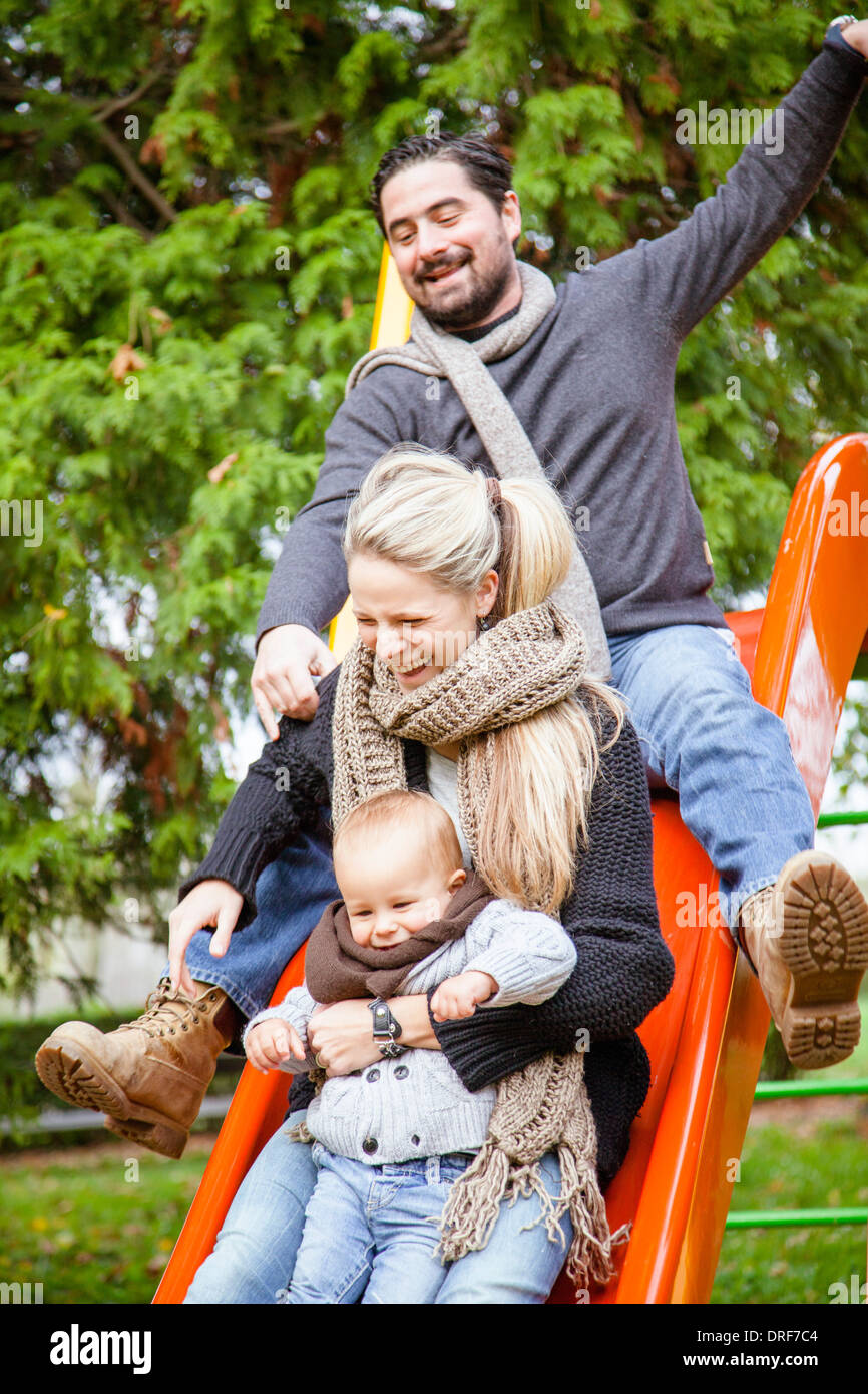 Family with one child on a slide, Osijek, Croatia Stock Photo