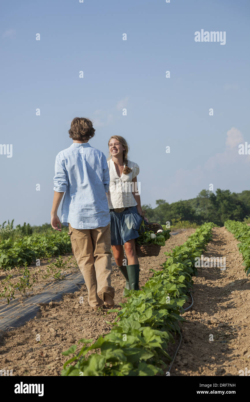 Maryland USA girl leading boy by the hand growing produce Stock Photo