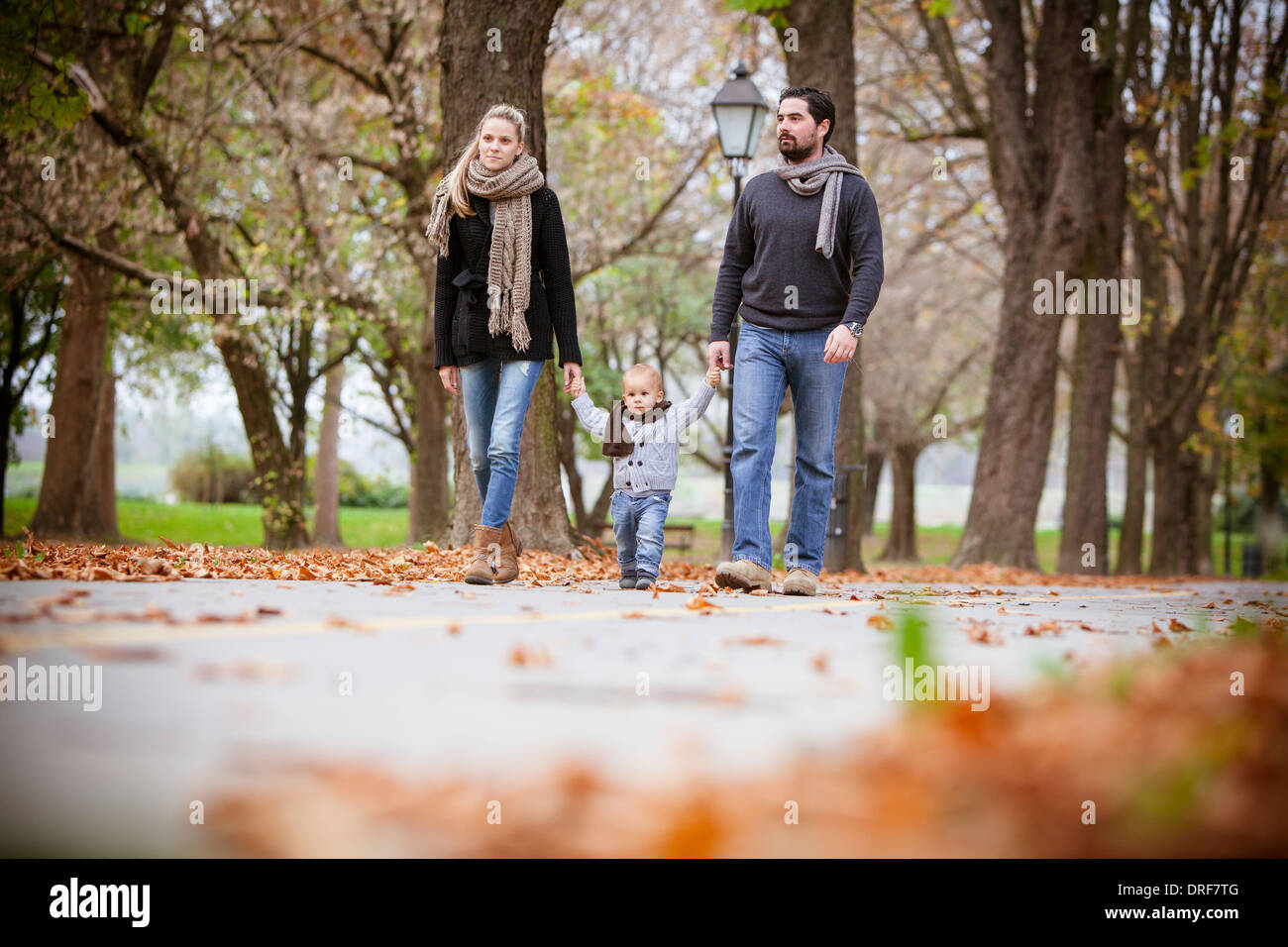 Family with one child taking a walk in autumn, Osijek, Croatia Stock Photo