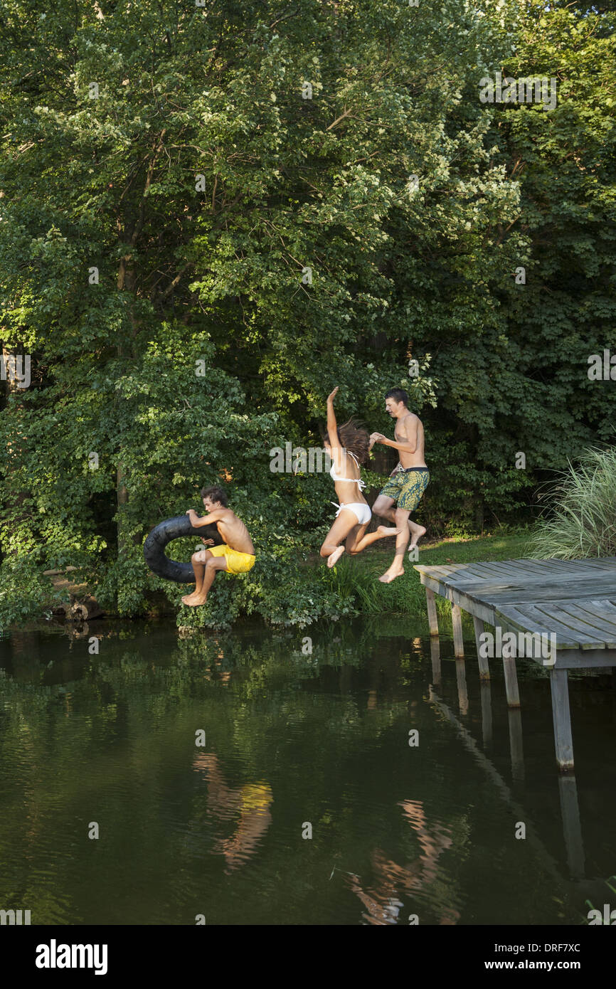 Maryland USA Three young boys jumping from the jetty Stock Photo