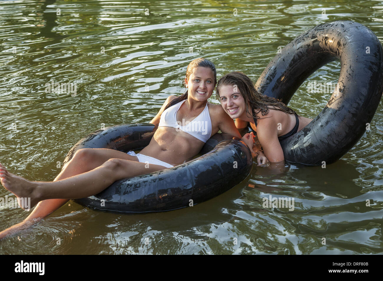 maryland-usa-two-girls-swimming-and-floating-using-swim-floats-DRF80B.jpg