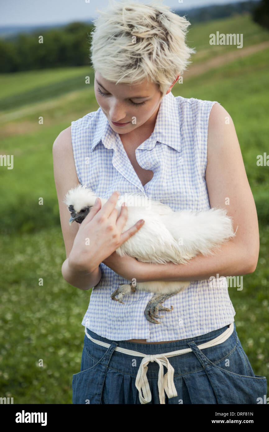 Maryland USA young girl teenager holding chicken white feathers Stock Photo