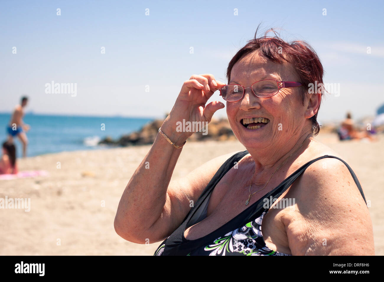 Portrait of happy senior woman relaxing on the beach Stock Photo - Alamy