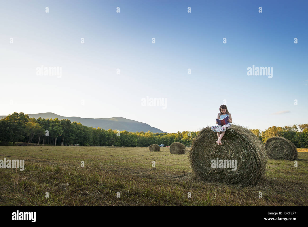 New York state USA hay bales girl sitting on the top of bale Stock