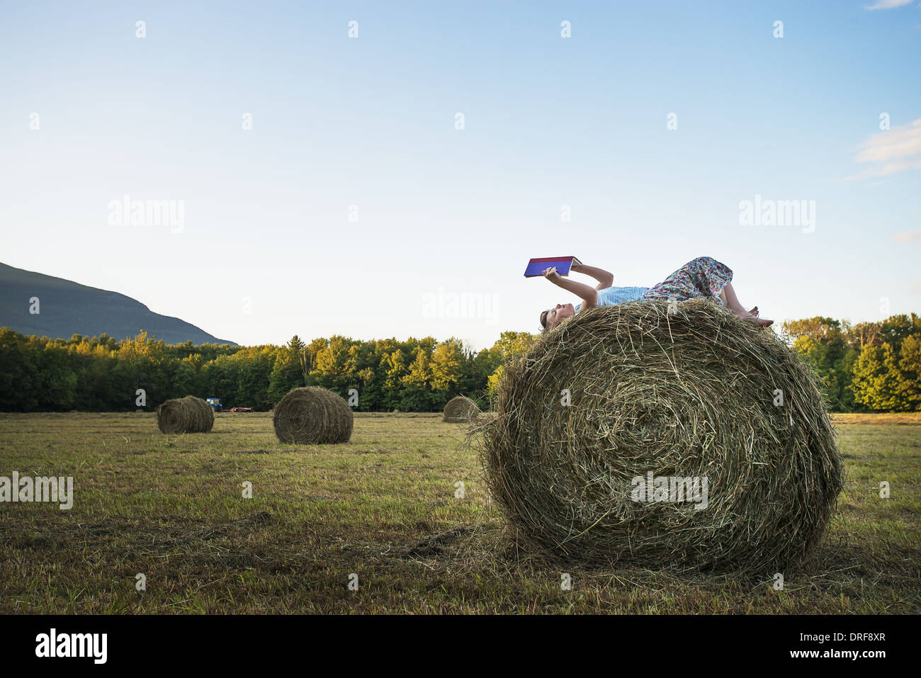 New York state USA hay bales girl sitting on the top of bale Stock
