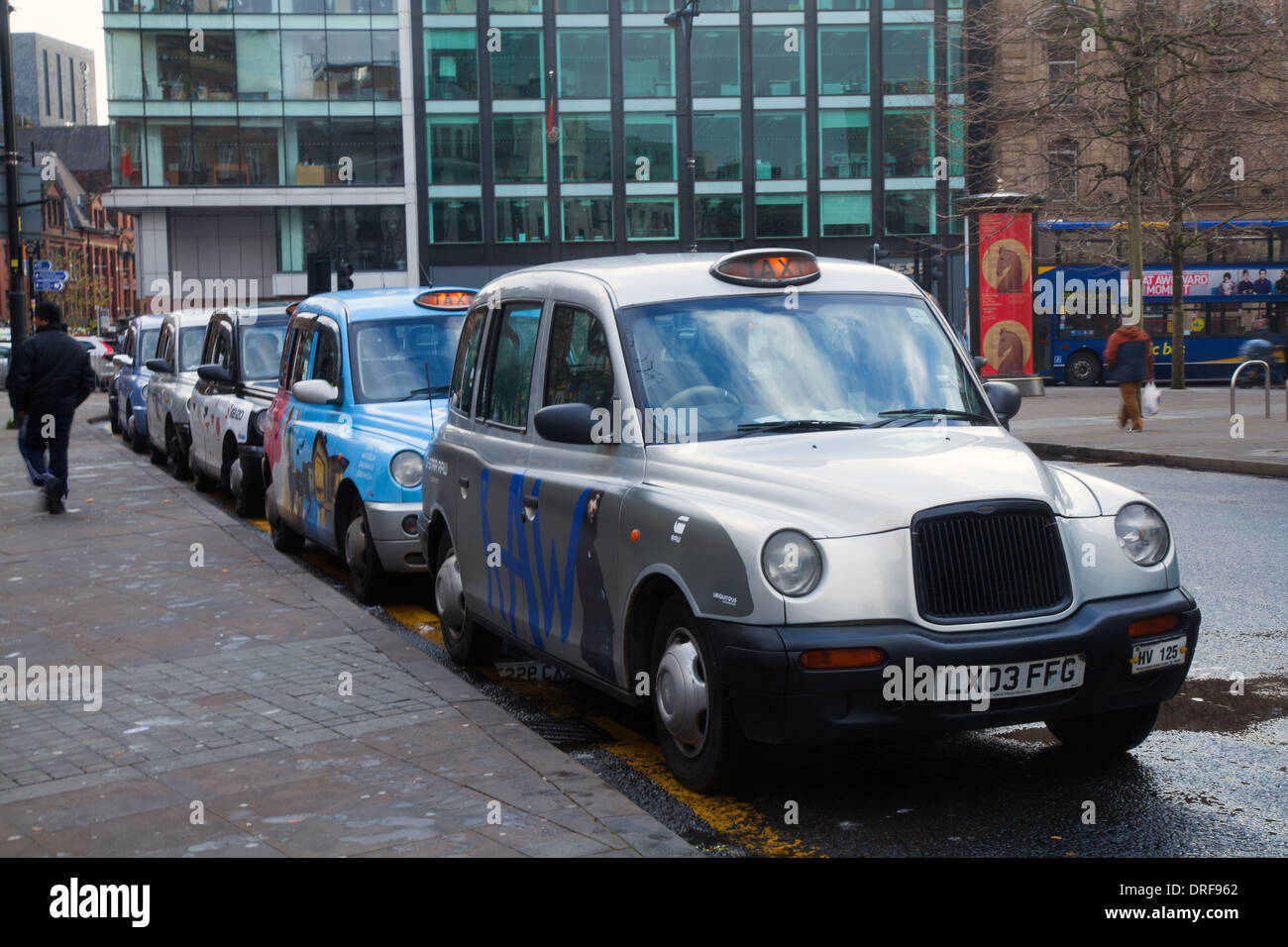 London Taxis Int Txii Bronze Auto. Colourful Piccadilly Hackney Cabs,  Private Hire Vehicles  Taxis in Manchester City Centre, UK. Stock Photo