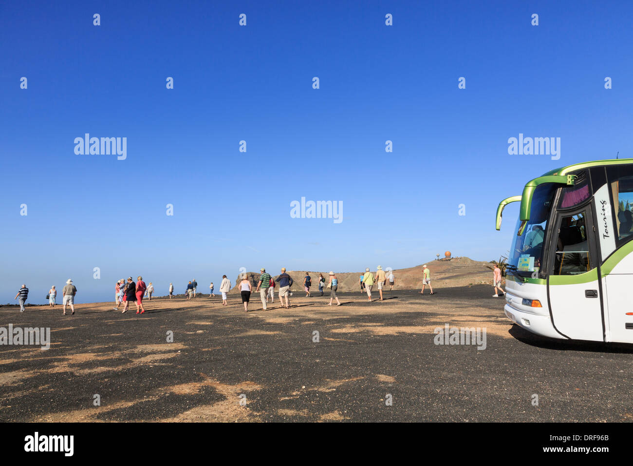 British tourists and tourist coach at Famara viewpoint near Haria, Lanzarote, Canary Islands, Spain Stock Photo