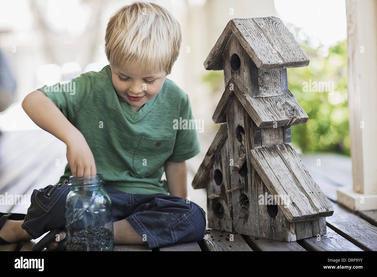 Utah USA child examining bug box on porch Stock Photo