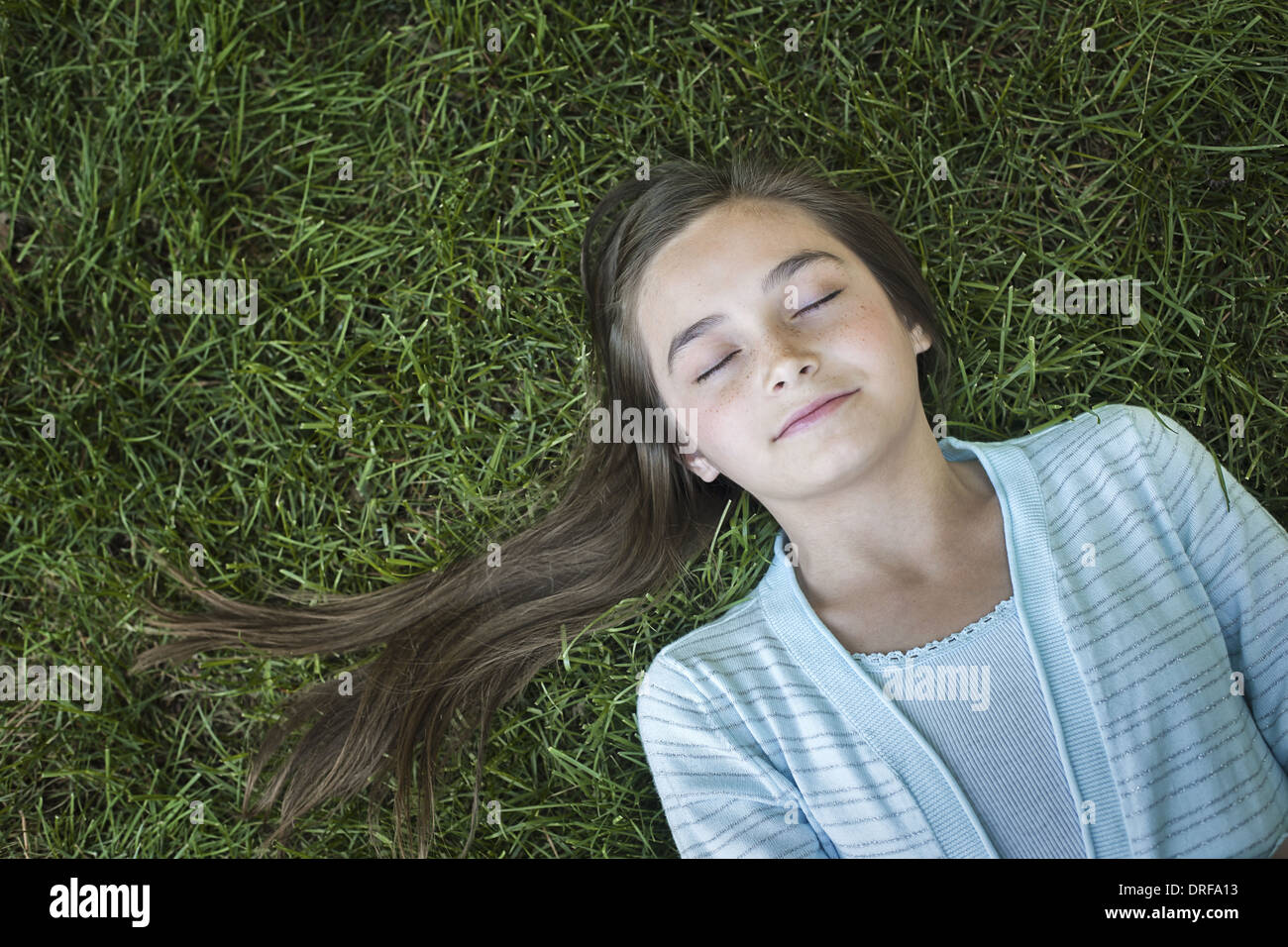 Utah USA girl with long hair fanned out asleep grass Stock Photo