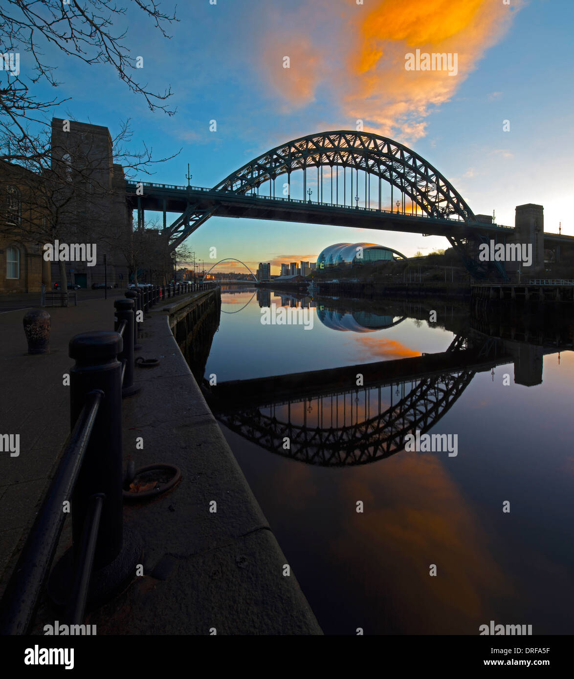 a view of the Tyne Bridge at dawn reflected in the River Tyne in Newcastle upon Tyne looking downriver towards the Gateshead Stock Photo