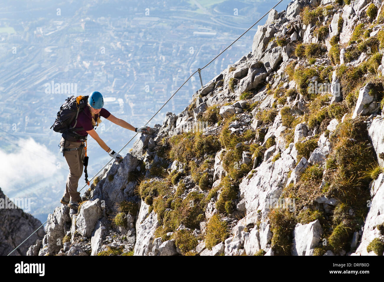 Female alpinist rock climbing, Innsbruck route, Tyrol, Austria Stock