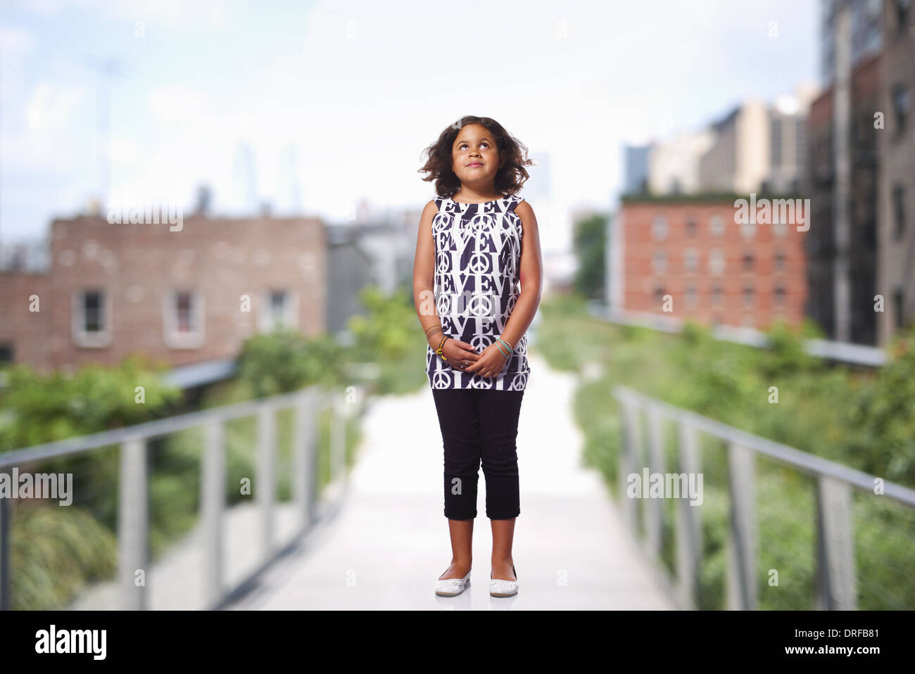 child standing in green space in the city Stock Photo