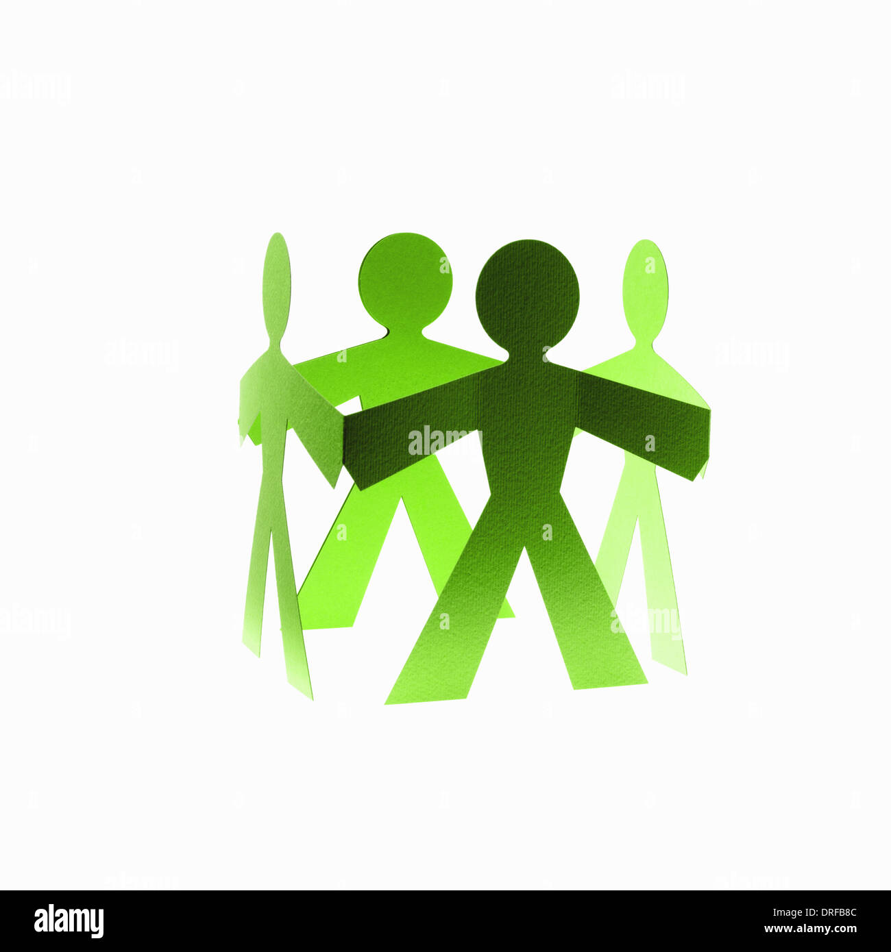 Papercuts paper cut out people with joined hands Stock Photo