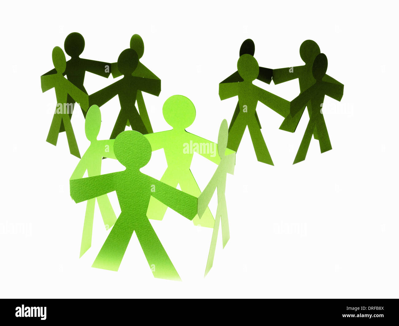 Papercuts paper cut out people with joined hands Stock Photo