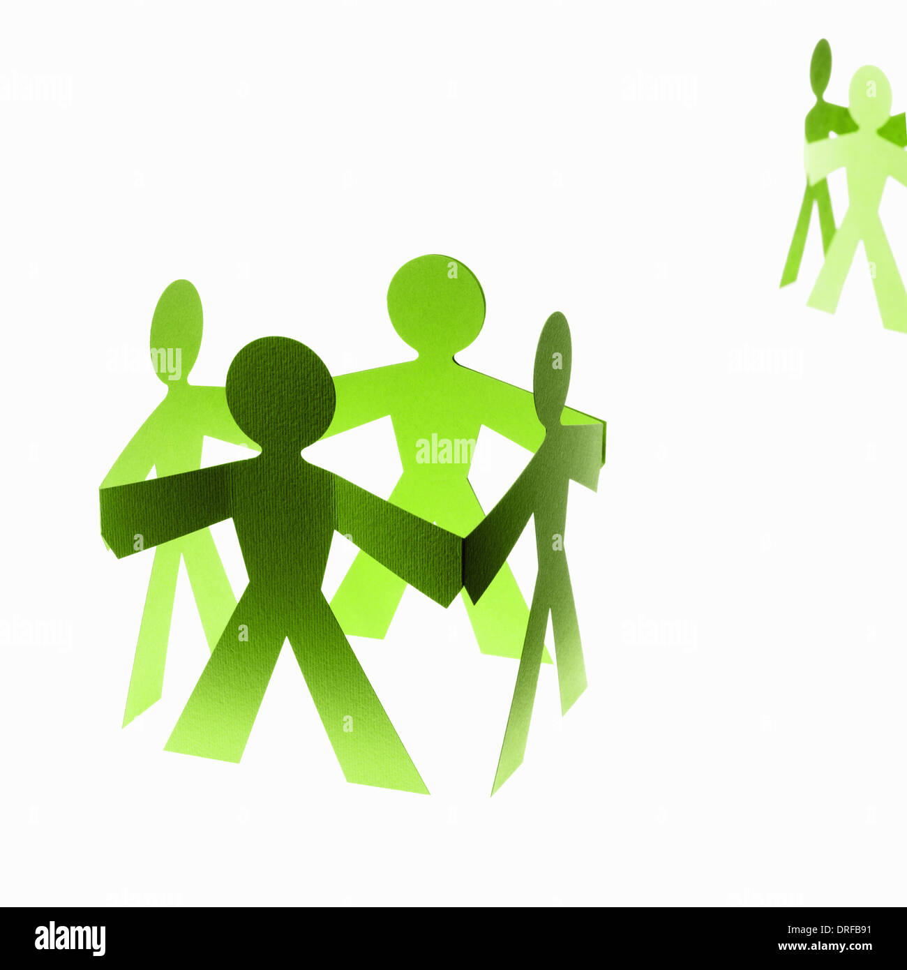 Papercuts paper cut out people with joined hands Stock Photo