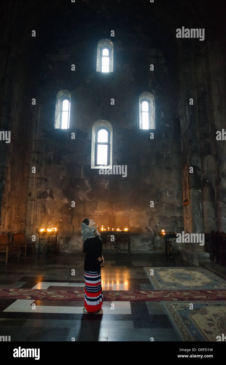 Woman prays in Tatev Monastery, Armenia Stock Photo