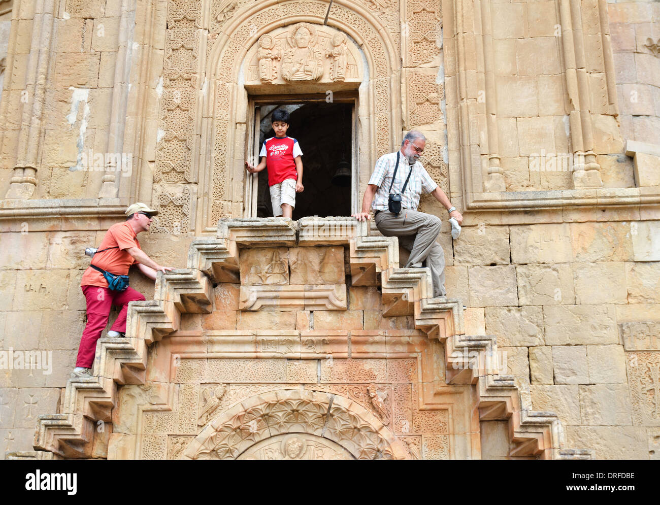 Tourists walk up stairs of Surb Astvatsatsin (Holy Mother of God) Church, Noravank, Armenia Stock Photo
