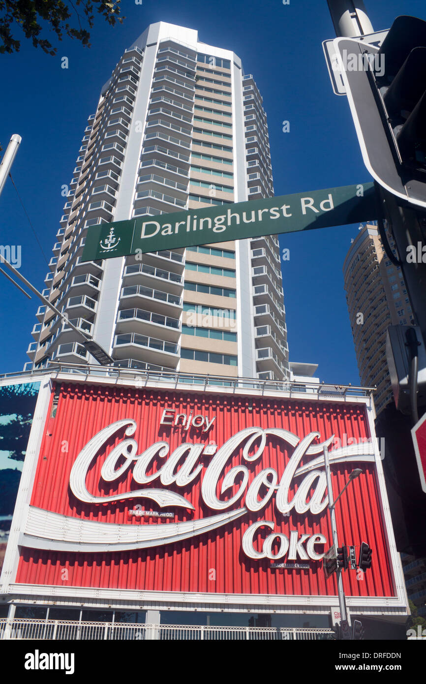 Coke Coca-Cola sign with Darlinghurst Road street sign and tower block above Kings Cross Sydney New South Wales NSW Australia Stock Photo