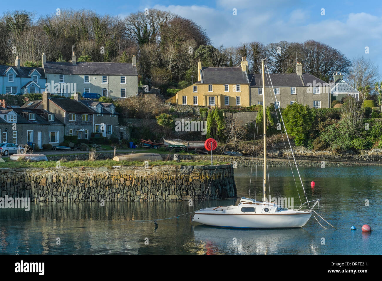 Postcard view of Strangford town, Co Down, taken from the quayside overlooking a moored yacht in a sheltered bay. Stock Photo