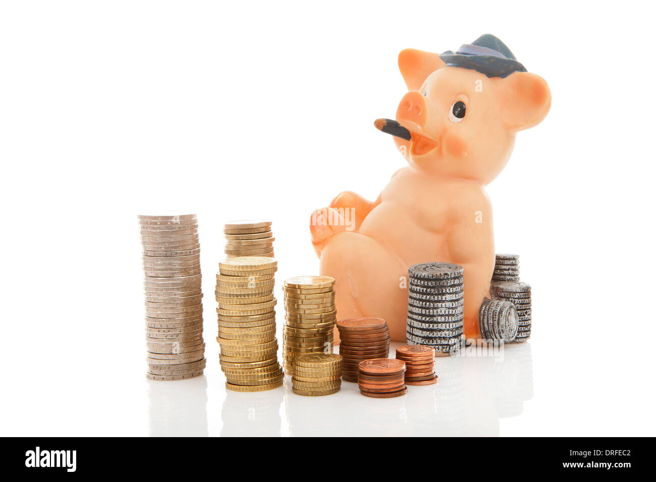 piggy bank and piles of coins over white background Stock Photo - Alamy