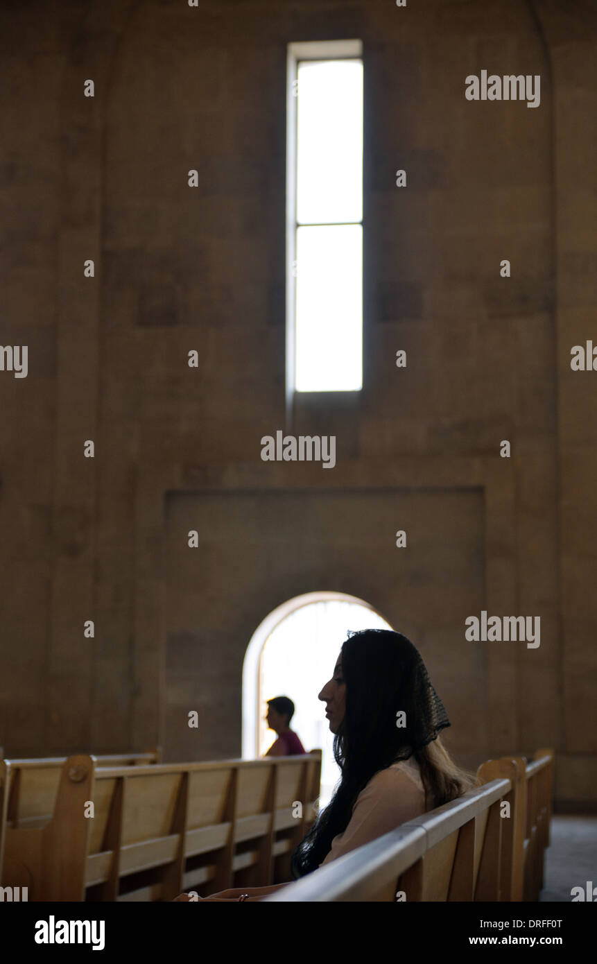 Woman prays in Saint Gregory the Illuminator Cathedral, Yerevan, Armenia Stock Photo