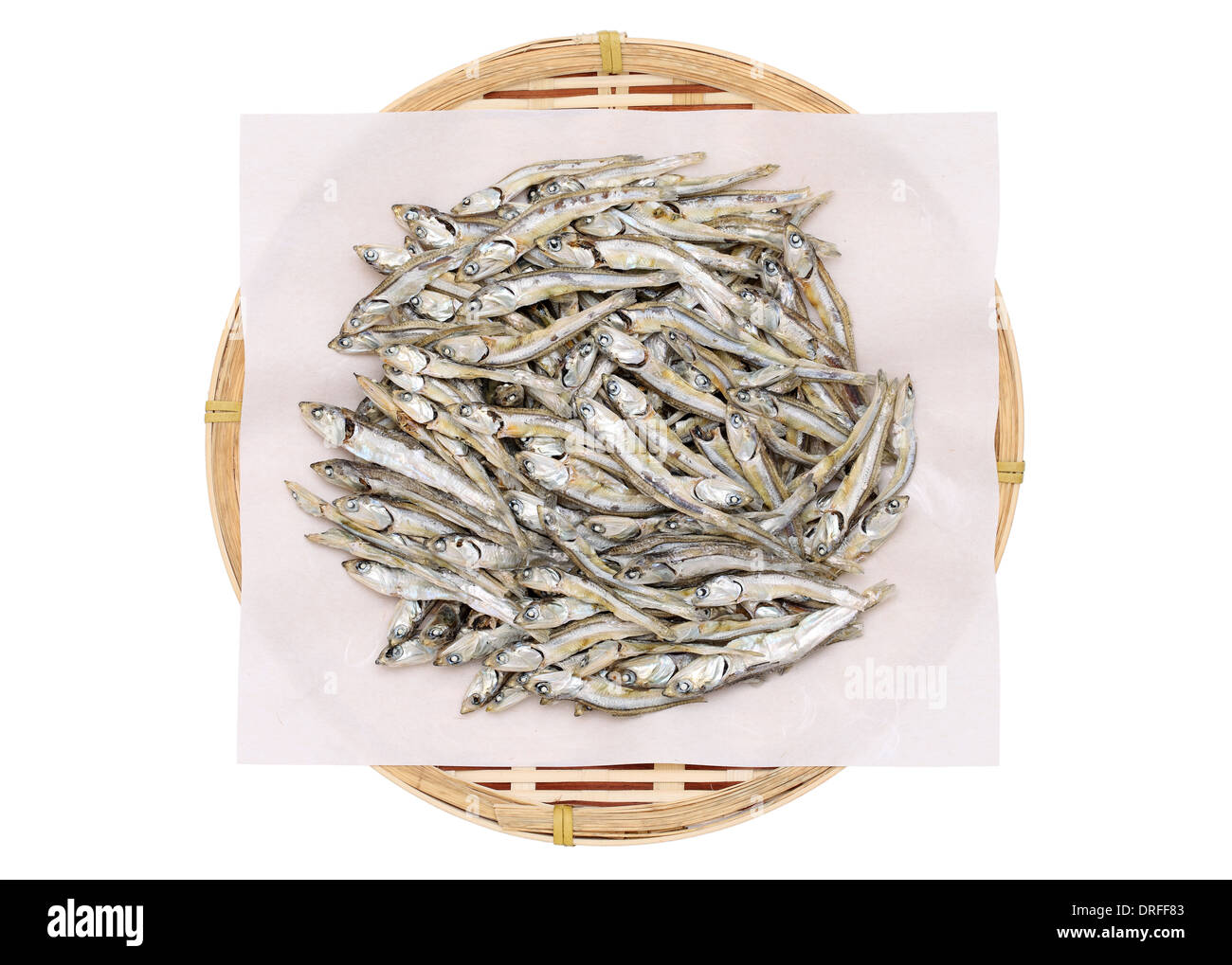 Dried small fish on bamboo colander Stock Photo