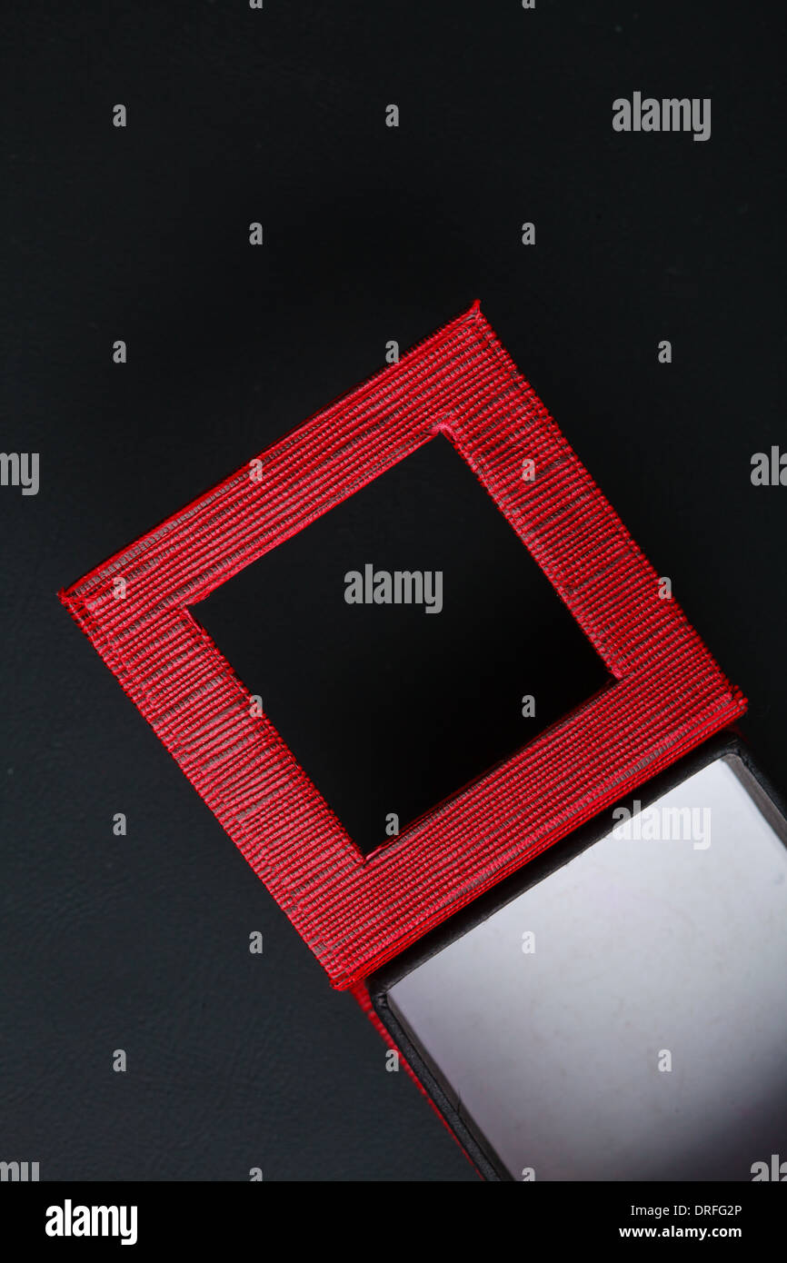 Red black rectangular ring jewellery box on dark background Stock Photo