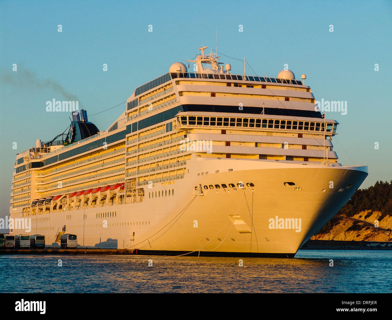 luxury cruising ship is moored at the pier but ready to sail into the ...