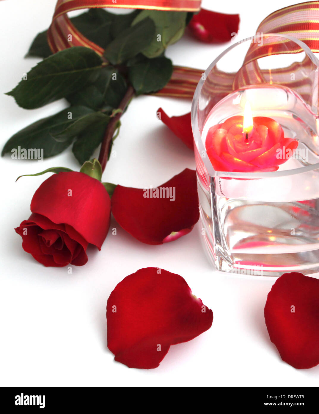 Beautiful red rose and red candle over white background Stock Photo - Alamy