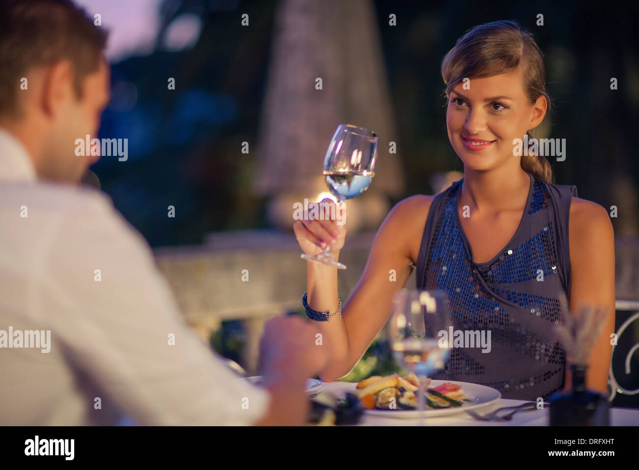 Young couple drinking white wine in restaurant, Dubrovnik, Croatia Stock Photo