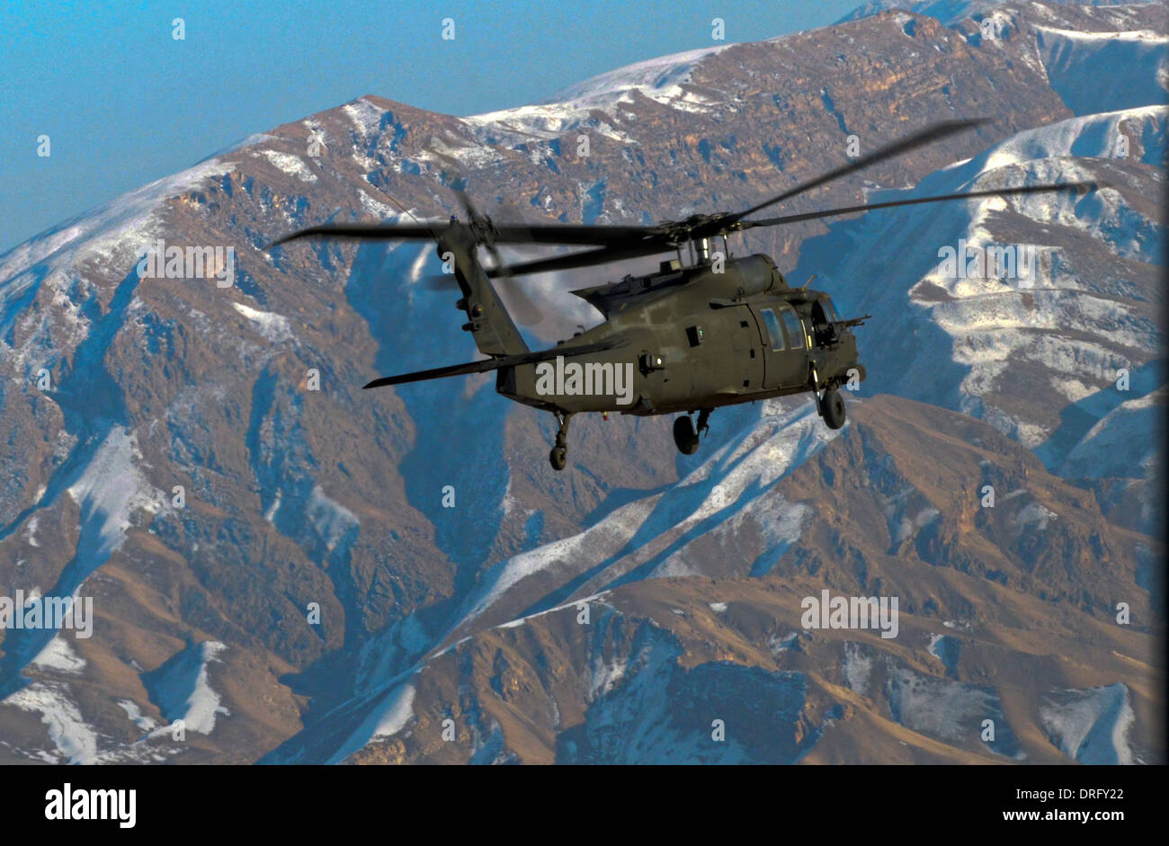 A US Army UH-60M Black Hawk helicopter flies through the Salang Pass January 15, 2014 in Afghanistan. Stock Photo