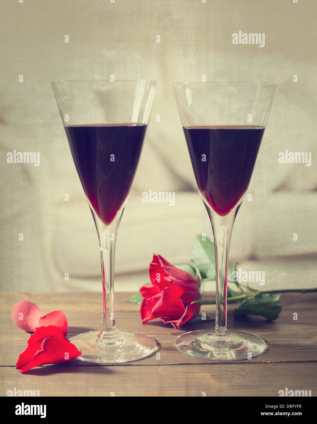 Two glasses of red wine with rose and petals Stock Photo - Alamy