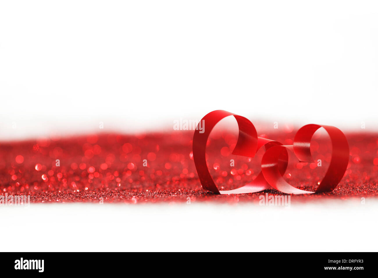 Valentines day decorative hearts on red glitter background Stock Photo ...