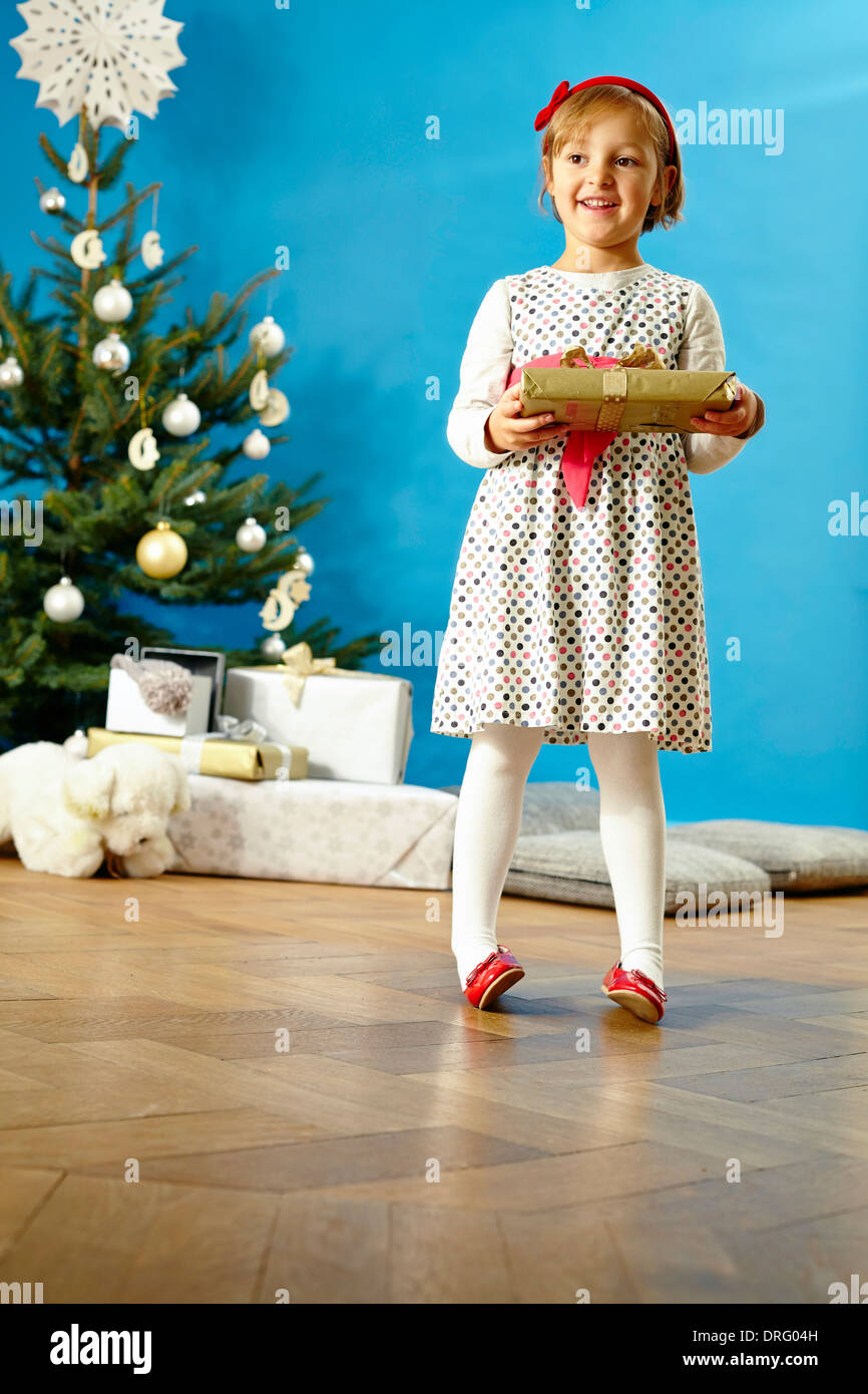 Little girl holding Christmas present, Munich, Bavaria, Germany Stock Photo