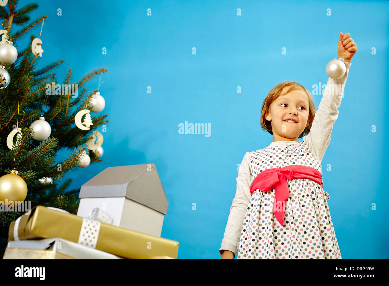 Little girl holding Christmas bauble, Munich, Bavaria, Germany Stock Photo