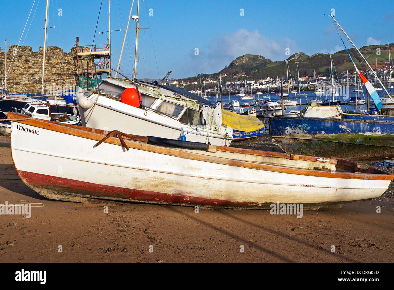 Boats hauled out on beach at Conwy harbour at low water. Stock Photo