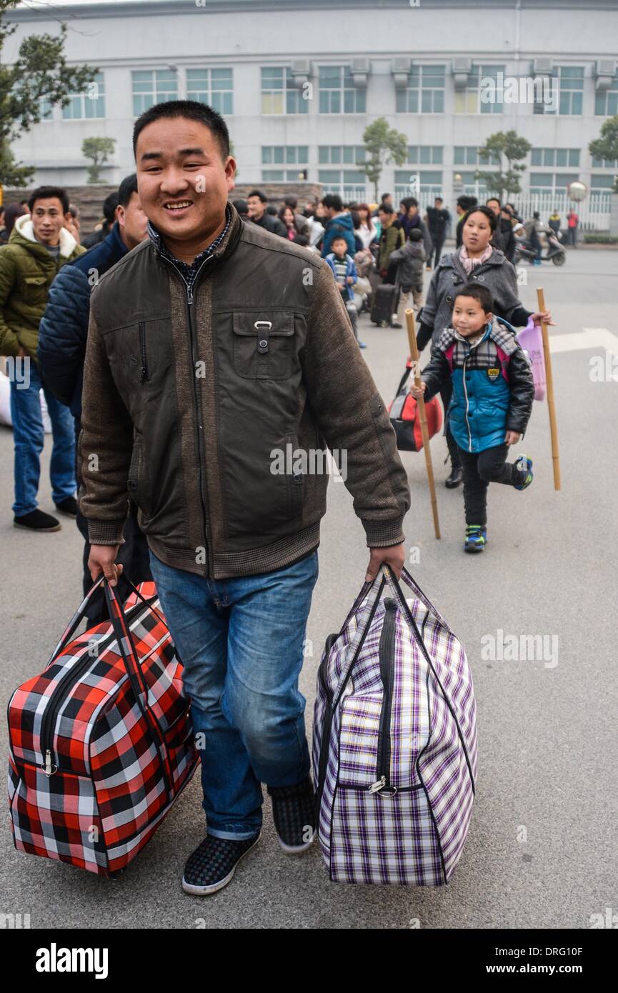 Anji, China's Zhejiang Province. 25th Jan, 2014. A worker of Henglin Chair Industry, a local private company, prepares to board a chartered bus to return home in Anji County, east China's Zhejiang Province, Jan. 25, 2014. Henglin chartered 20 buses to send its workers home for free for family reunion prior to the Spring Festival, which falls on Jan. 31 this year. © Xu Yu/Xinhua/Alamy Live News Stock Photo
